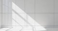Sunlight streams through a large window, casting shadows on a pristine, white-tiled wall and floor. Royalty Free Stock Photo