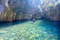 Woman exploring river cave and canyon