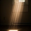 Sunlight streams through a window, illuminating floating dust particles in an Royalty Free Stock Photo