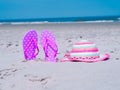 Sunlight Summer composition. Beach flip flops on tropical ocean sand. against blue sea and sky background. Beach Accessories Royalty Free Stock Photo