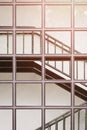 Sunlight on surface of glass wall with black metal staircase inside of modern building Royalty Free Stock Photo