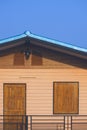 Vintage upstairs wooden house with black steel terrace against blue sky background Royalty Free Stock Photo