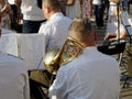 Sunlighted adult saxhornist and reflections in his saxhorn Royalty Free Stock Photo