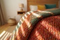 Cozy bedroom with sunlight streaming through window onto textured blanket Royalty Free Stock Photo