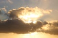 Sunlit clouds and rays of sunshine near sunset Royalty Free Stock Photo
