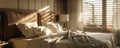 Sunlit cozy bedroom interior with unmade bed Royalty Free Stock Photo