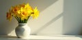 Sunlit daffodil bunch in simple vase, dramatic shadow, photography, shadow, dark Royalty Free Stock Photo