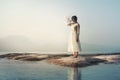 sunlit gear clock held by a woman in the middle of the lake