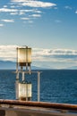 Sunlit glass and metal sternlight of ship. Stephen`s Passage, Alaska, USA. Royalty Free Stock Photo