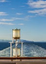 Sunlit glass and metal sternlight of ship. Stephen`s Passage, Alaska, USA. Royalty Free Stock Photo