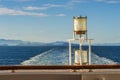 Sunlit glass and metal sternlight of ship. Stephen`s Passage, Alaska, USA. Royalty Free Stock Photo