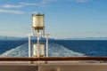 Sunlit glass and metal sternlight of ship. Stephen`s Passage, Alaska, USA. Royalty Free Stock Photo