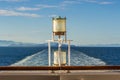 Sunlit glass and metal sternlight of ship. Stephen`s Passage, Alaska, USA. Royalty Free Stock Photo