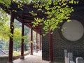 Sunlit green leaves and ancient Chinese architecture