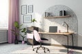 Sunlit home office work place with city view background from window with pink curtain, wheel chair and tea cup, wooden table on Royalty Free Stock Photo