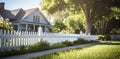 Sunlit Home with White Picket Fence Royalty Free Stock Photo