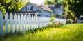 Sunlit Home with White Picket Fence Royalty Free Stock Photo