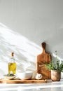Sunlit Kitchen Counter With Olive Oil, Fresh Herbs, and Cooking Utensils in the Morning Royalty Free Stock Photo