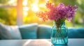 Sunlit lilacs in blue glass vase on table with blurred background Royalty Free Stock Photo