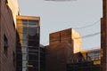 Sunlit stone-made exterior walls of office block building with a small balcony and mirror windows Royalty Free Stock Photo