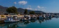 Sunlit Multi-Colored Mediterranean Fishing Boats Anchored on Water in Euboea - Nea Artaki, Greece Royalty Free Stock Photo