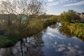 Sunlit Musselburgh river scene with reflections and budding trees Royalty Free Stock Photo