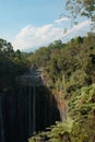 Sunlit Oasis: Tumpak Sewu Waterfall Framed by Mount Semeru