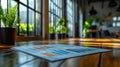 Sunlit office with data charts on wooden table, modern business, analytical work, natural light, shallow depth of field Royalty Free Stock Photo