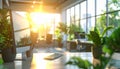 Sunlit office desk with computer, plants, and blurred background of windows and greenery Royalty Free Stock Photo