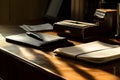 Sunlit office desk with notepad, pen, and briefcase in morning light Royalty Free Stock Photo
