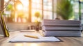 Sunlit office desk with a stack of papers and writing tools Royalty Free Stock Photo