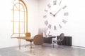 Sunlit office with large wall clock
