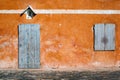 Sunlit orange old wall with balcony. Royalty Free Stock Photo