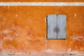 Sunlit orange old wall with balcony. Royalty Free Stock Photo