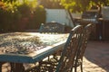 sunlit patio table with chairs tucked in
