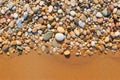 sunlit pebbles on a sandy beach