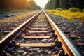 Sunlit railway track with ballast gravel, a scenic railroad landscape