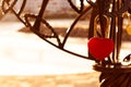 Sunlit red padlock in shape of a heart