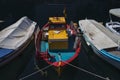 Sunlit Red, Turquoise and Yellow Mediterranean Fishing Boat on Water in Euboea - Nea Artaki, Greece Royalty Free Stock Photo