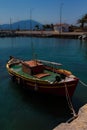 Sunlit Red, Yellow, Green and Orange Mediterranean Fishing Boat on Water in Euboea - Nea Artaki, Greece Royalty Free Stock Photo