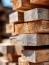 Stacked rough cut lumber with natural wood grain texture and warm sunlight highlighting the details on weathered edges in a Royalty Free Stock Photo
