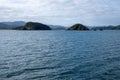 Sunlit seascape view with cloudy sky background, Bay of islands