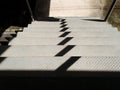 Sunlit steel stairs. And shadows caused by sunlight. Royalty Free Stock Photo
