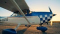 Sunlit take-off runway with a cropduster slowing moving along it