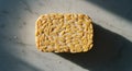 Sunlit Tempeh Block on Marble Surface Royalty Free Stock Photo