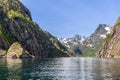 The sunlit Trollfjorden in Lofoten, Norway, is a symphony of nature\'s bright summer colors