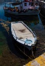 Sunlit White and Blue Mediterranean Fishing Boat on Water in Euboea - Nea Artaki, Greece Royalty Free Stock Photo