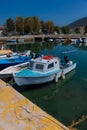 Sunlit White and Blue Mediterranean Fishing Boat on Water in Euboea - Nea Artaki, Greece Royalty Free Stock Photo
