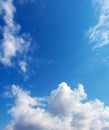 Sunlit white clouds in the blue sky, vertical format Royalty Free Stock Photo