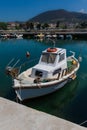 Sunlit White and Orange Mediterranean Fishing Boat on Water in Euboea - Nea Artaki, Greece Royalty Free Stock Photo